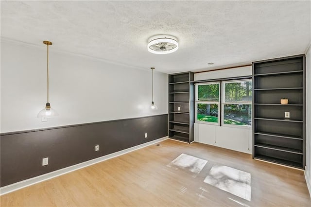 364 Stafford St SW, Marietta, GA 30064 - empty room with wood finished floors, a textured ceiling, and built in shelves