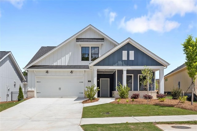 view of front of house featuring driveway, a shingled roof, a front lawn, and board and batten siding
