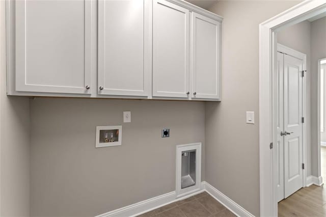 clothes washing area featuring cabinet space, tile patterned floors, electric dryer hookup, baseboards, and hookup for a washing machine