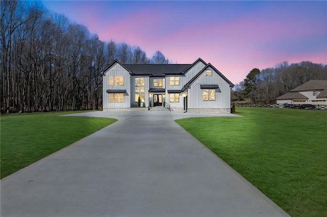 modern inspired farmhouse with a yard