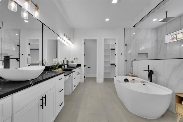 bathroom with tile patterned flooring, vanity, and shower with separate bathtub