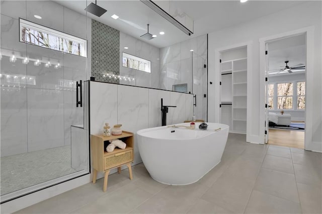 bathroom with ceiling fan, tile patterned floors, and plus walk in shower