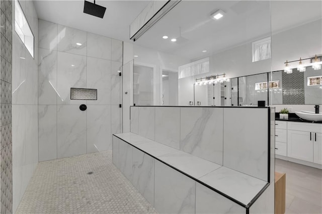 bathroom with vanity and a tile shower