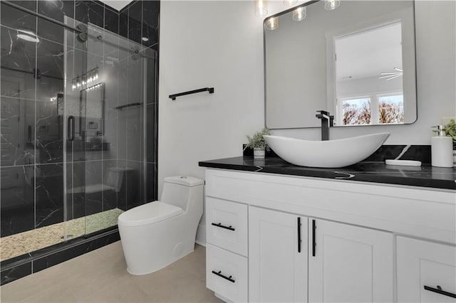 bathroom featuring toilet, vanity, tile patterned flooring, and an enclosed shower