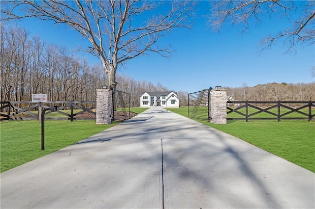 view of gate with a yard