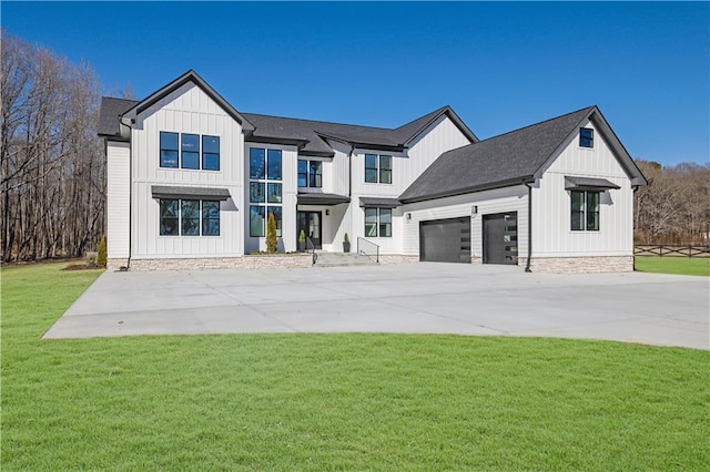 rear view of house featuring a garage and a yard