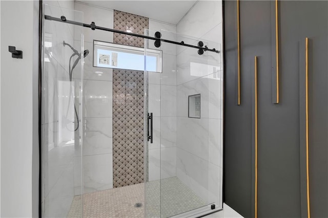 bathroom with a shower with door