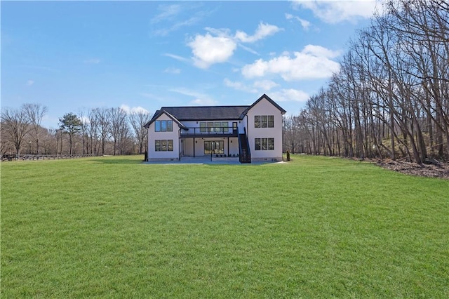 back of house featuring a patio and a yard