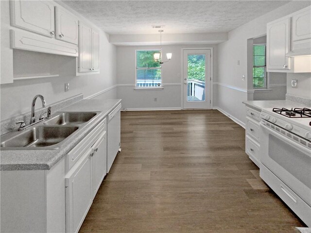 kitchen with dark wood-type flooring, white cabinets, white appliances, pendant lighting, and sink