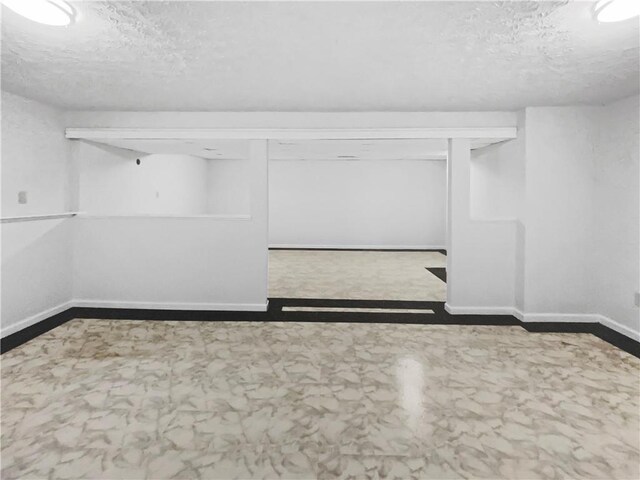 basement featuring a textured ceiling