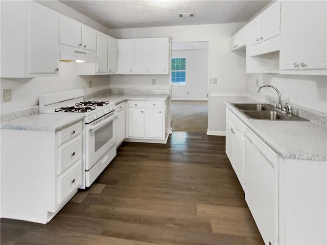 kitchen featuring white appliances, white cabinetry, dark hardwood / wood-style flooring, and sink