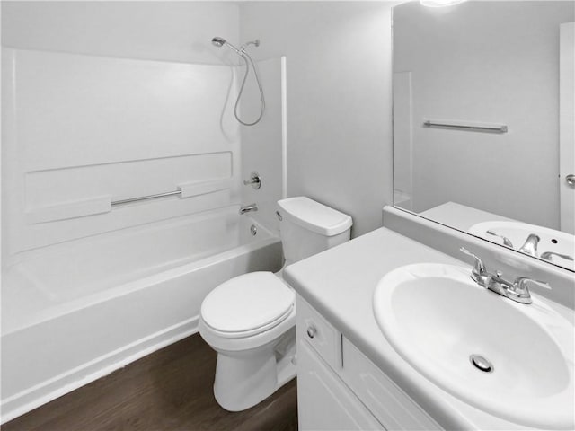 full bathroom featuring washtub / shower combination, vanity, toilet, and wood-type flooring