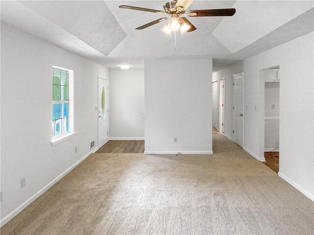 carpeted empty room featuring ceiling fan