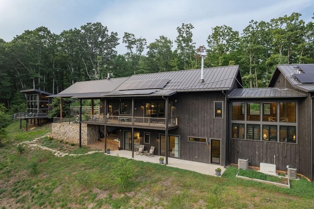 rear view of property with a patio area and a lawn