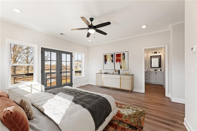 bedroom featuring french doors, ensuite bath, ceiling fan, crown molding, and dark wood-type flooring