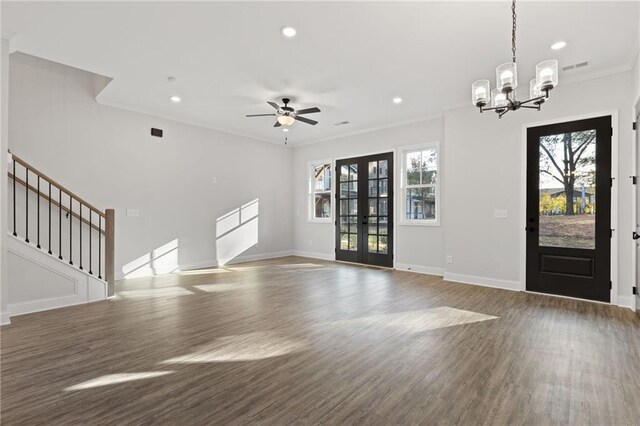 entryway with a wealth of natural light, crown molding, dark wood-type flooring, and ceiling fan with notable chandelier