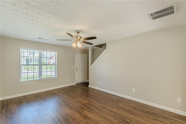 5280 Tussahaw Xing, Mcdonough, GA 30252 - empty room featuring baseboards, a textured ceiling, visible vents, and dark carpet