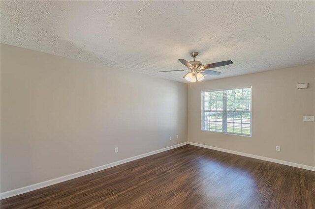 5280 Tussahaw Xing, Mcdonough, GA 30252 - empty room featuring a textured ceiling, baseboards, visible vents, and dark carpet