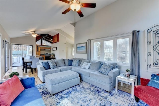 living room with ceiling fan, lofted ceiling, and wood finished floors