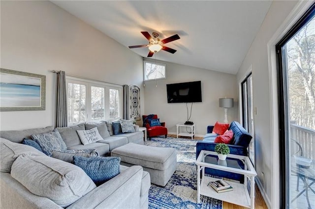 living room with vaulted ceiling, ceiling fan, plenty of natural light, wood finished floors, and baseboards