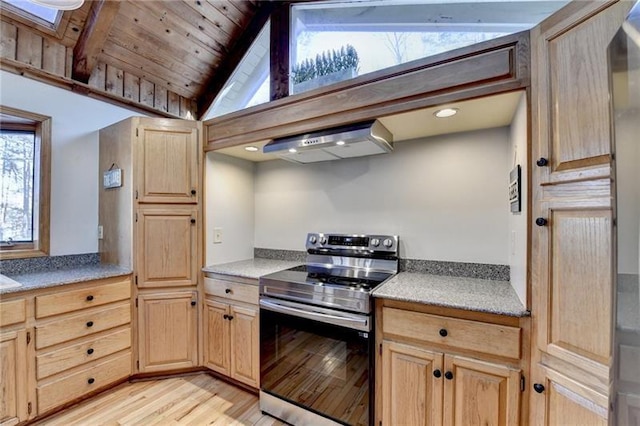 kitchen featuring stainless steel electric range oven, ventilation hood, light brown cabinets, light wood-type flooring, and vaulted ceiling