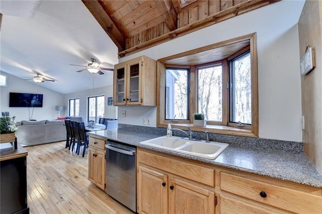 kitchen with dishwasher, a sink, light wood-style flooring, glass insert cabinets, and light brown cabinetry
