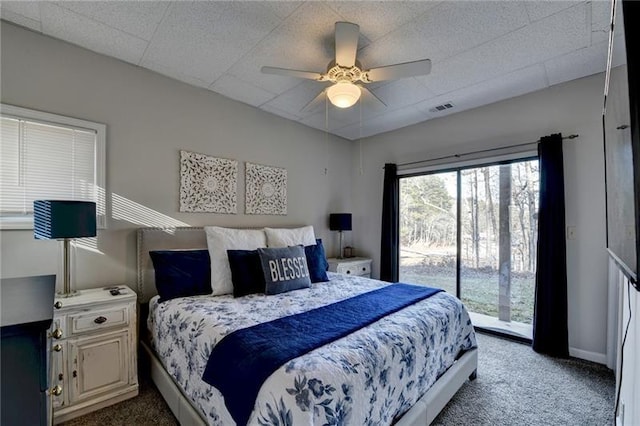 carpeted bedroom with access to outside, baseboards, and a ceiling fan
