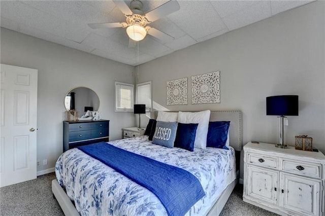 carpeted bedroom featuring a ceiling fan and baseboards