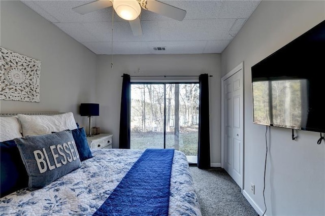 carpeted bedroom featuring a ceiling fan and access to exterior