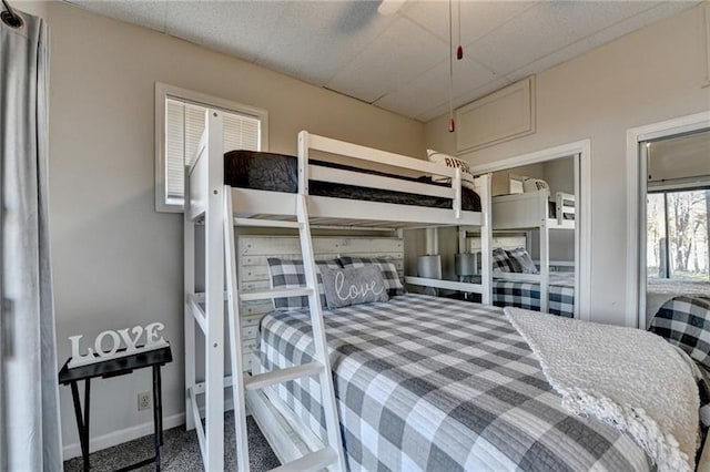 bedroom with attic access, carpet flooring, and baseboards