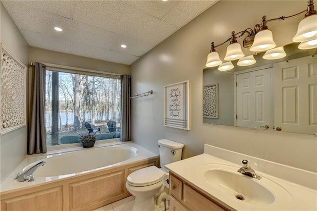 bathroom with a bath, toilet, vanity, recessed lighting, and tile patterned flooring