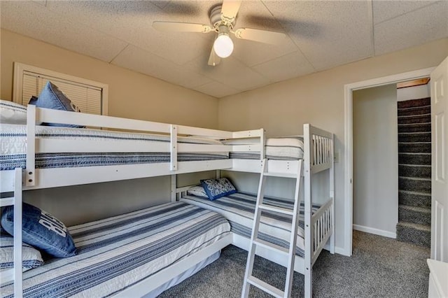 bedroom featuring carpet floors, a paneled ceiling, and baseboards