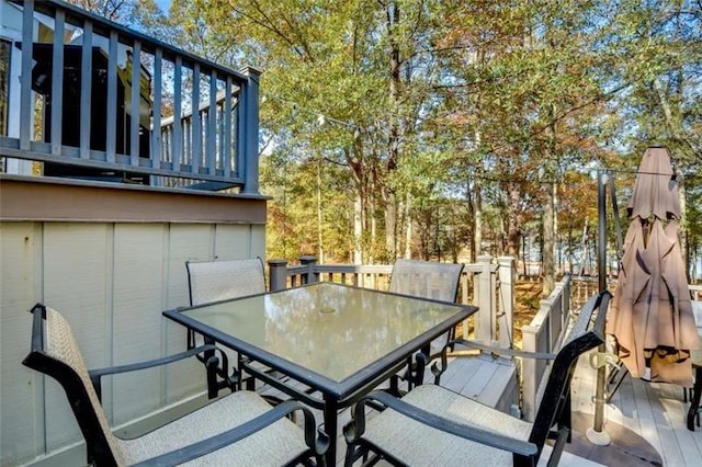 view of patio with outdoor dining area and a wooden deck