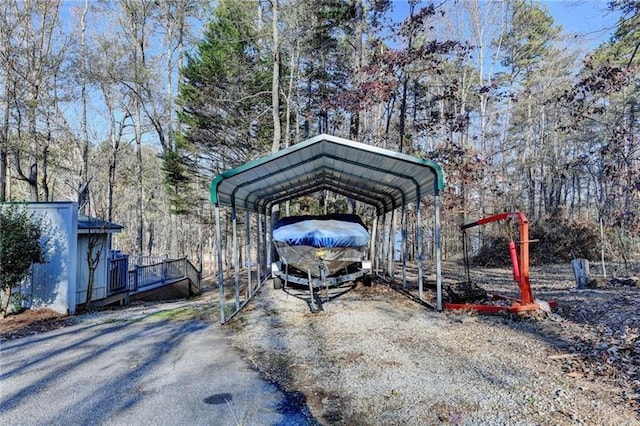 view of parking / parking lot with a detached carport and driveway
