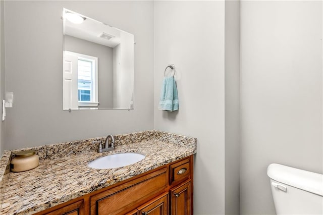 bathroom with vanity and toilet