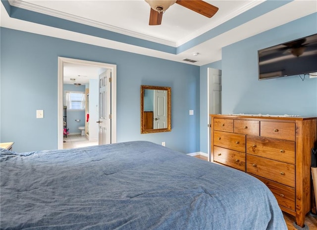 bedroom featuring ceiling fan, a raised ceiling, and ornamental molding