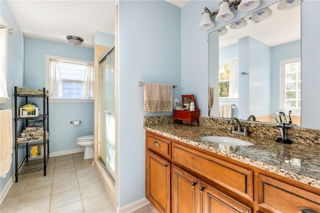 bathroom featuring tile patterned floors, vanity, walk in shower, and toilet