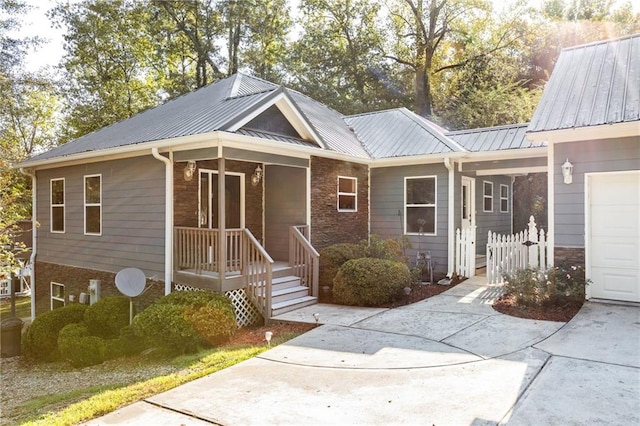 view of front of property featuring a garage and covered porch