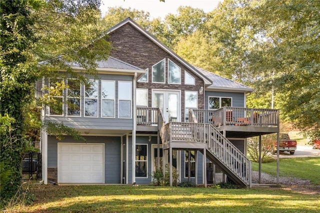 back of house with a garage, a deck, a yard, and central air condition unit