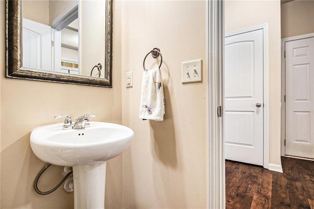 bathroom with a sink and wood finished floors