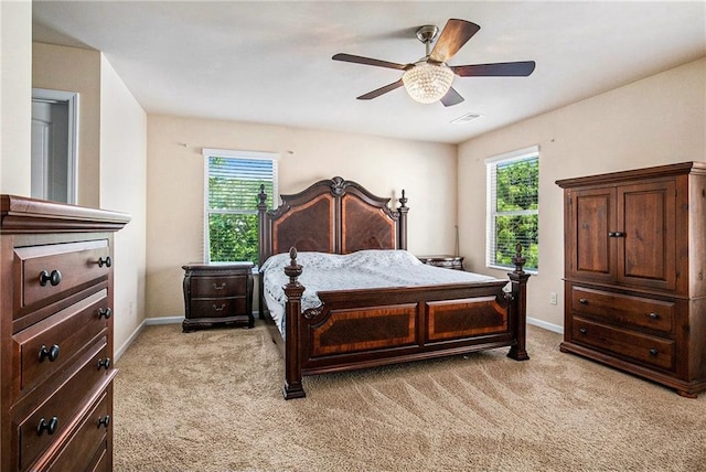 bedroom featuring multiple windows, light carpet, and visible vents
