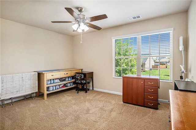 interior space featuring visible vents, baseboards, carpet floors, and multiple windows