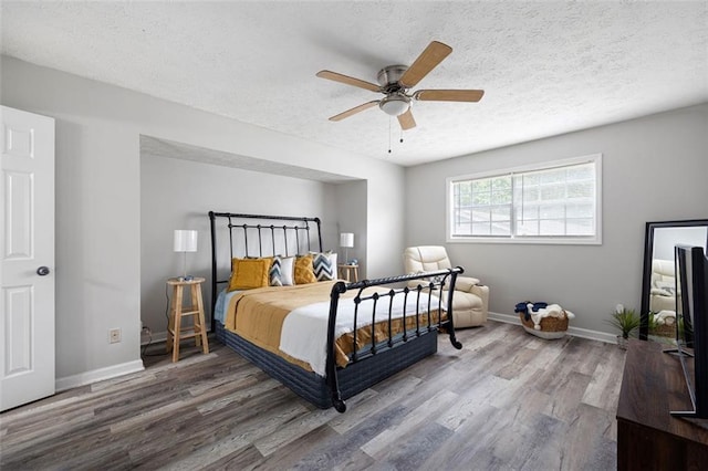 2103 Blue Creek Ct, Conley, GA 30288 - bedroom featuring wood finished floors, a textured ceiling, and ceiling fan