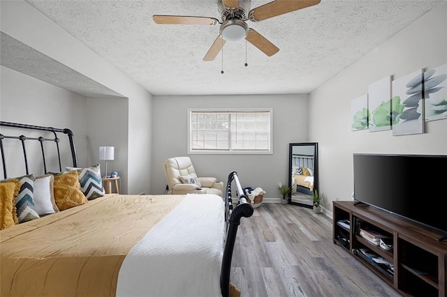 2103 Blue Creek Ct, Conley, GA 30288 - bedroom featuring wood finished floors, a textured ceiling, and a ceiling fan