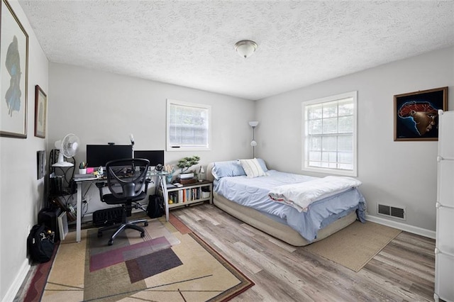 2103 Blue Creek Ct, Conley, GA 30288 - bedroom featuring wood finished floors, a desk, and a textured ceiling