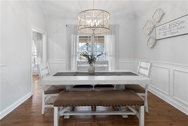 dining space featuring a decorative wall, an inviting chandelier, and a healthy amount of sunlight