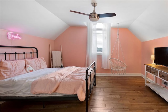 bedroom featuring baseboards, wood-type flooring, lofted ceiling, and a ceiling fan