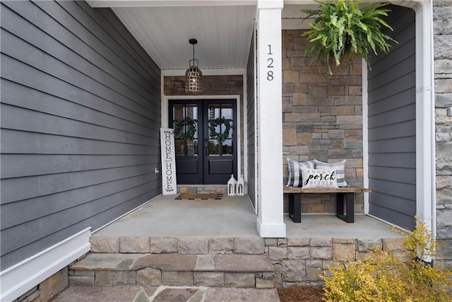 doorway to property featuring french doors and stone siding