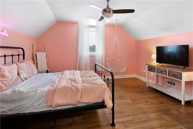 bedroom featuring ceiling fan, baseboards, wood finished floors, and vaulted ceiling