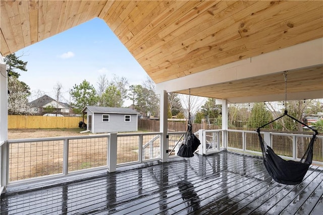 deck with an outdoor structure and fence